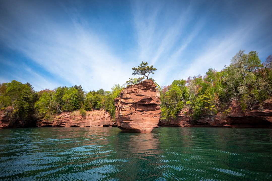 Photograph of Lake Superior sandstone rock stack under a blue sky.