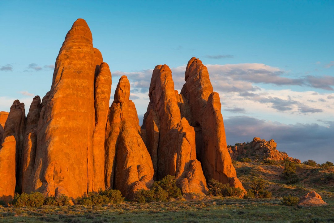 Red sandstone fins glow in sunset lighting