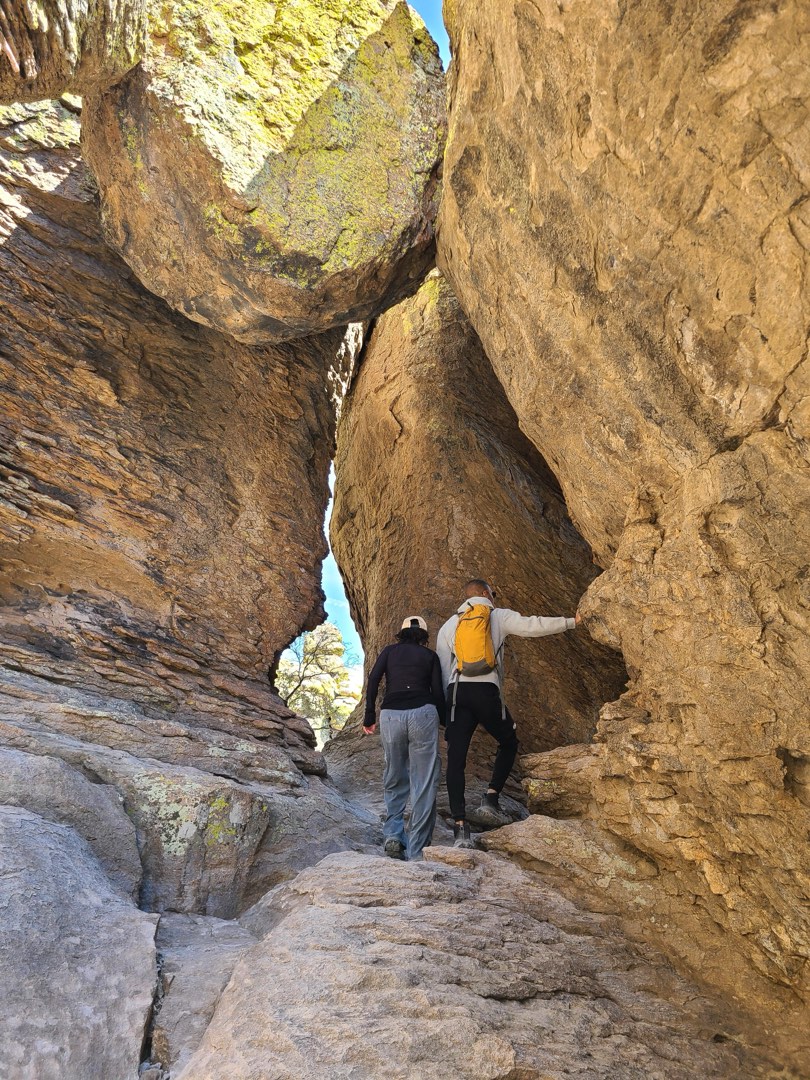 People climb through rock archways