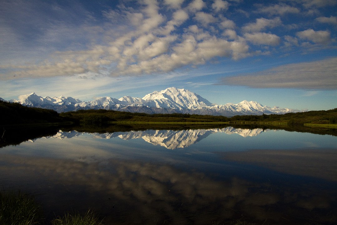 snowy mountains reflected in a pond