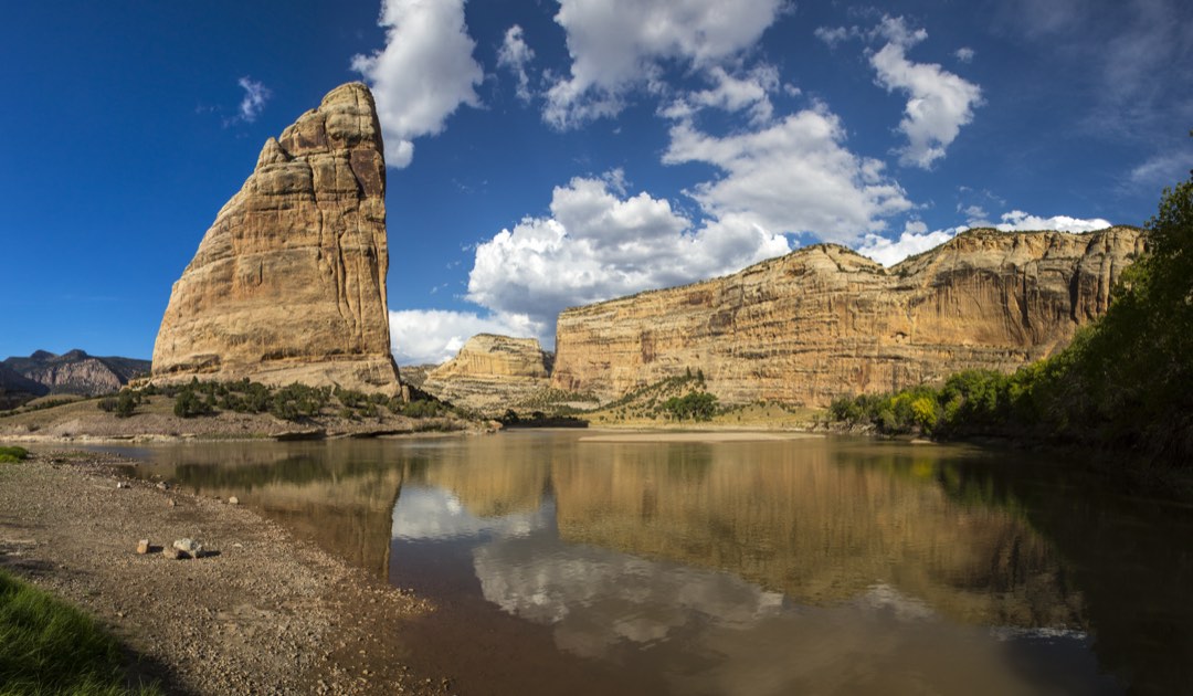 the rocky pinnacle of Steamboat Rock rises over the Green River