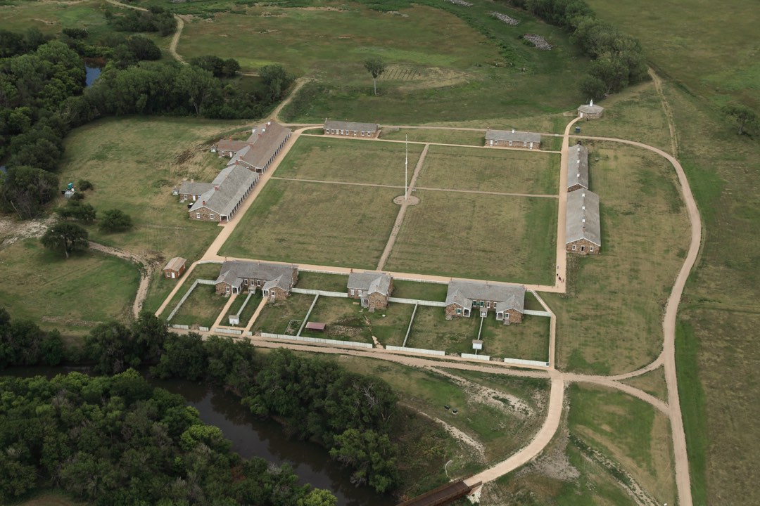 Sandstone army buildings arranged in a square around parade ground.