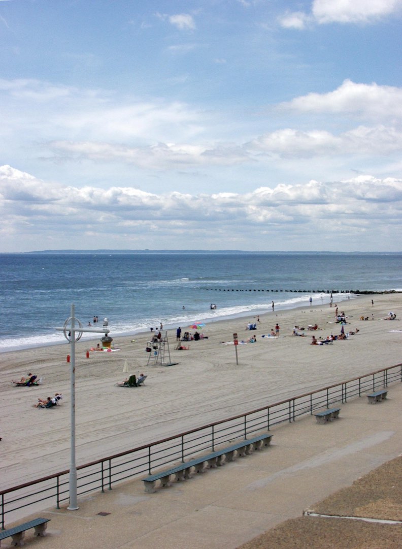 Visitors enjoying the sun and sand at Jacob Riis Park